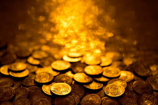 a pile of gold coins sitting on top of a table