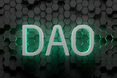 Silver-colored word DAO with a neon green shadow illuminates the black textured background.