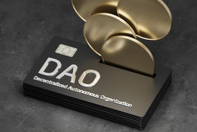 Golden coins emerging from a black device with a chip, featuring the term 'DAO' in silver.
