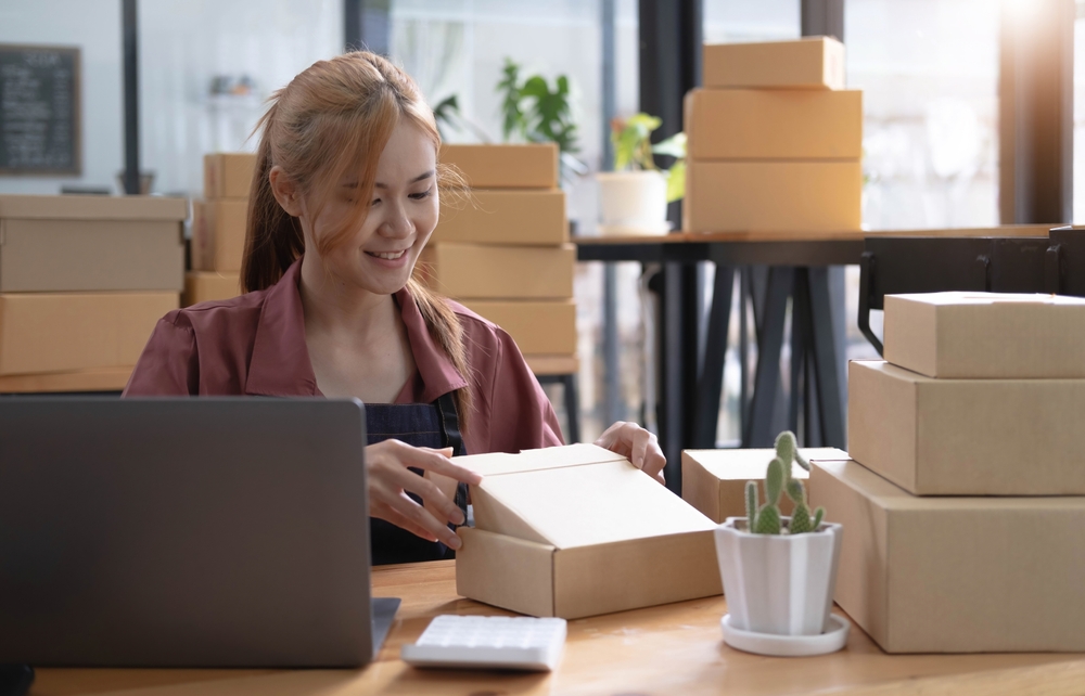 Woman packing boxes at a desk