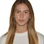a woman with long blonde hair wearing a white shirt