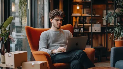 a man sitting in a chair with a laptop