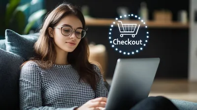 a woman sitting on a couch looking at a laptop