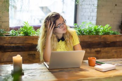 Stressed Shopify seller sitting in front of a laptop computer