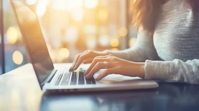 a woman using a laptop computer on a table