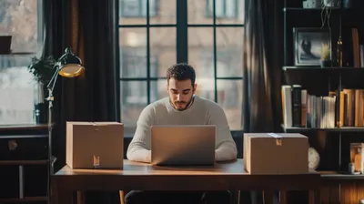 a man sitting at a table with a laptop in front of him