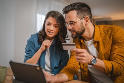 a man and a woman looking at a laptop