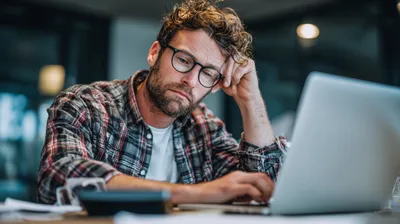a man sitting at a table with a laptop