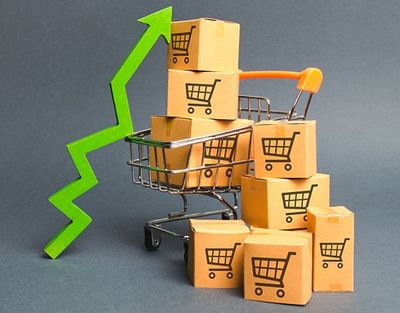 a shopping cart filled with boxes and a green arrow