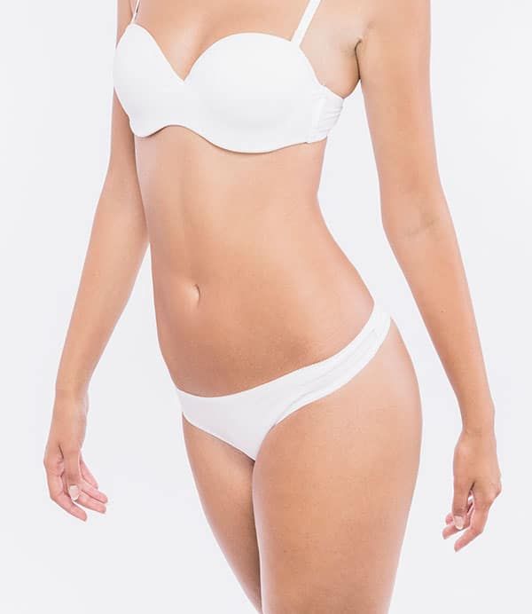 a woman in a white bikini top and panties