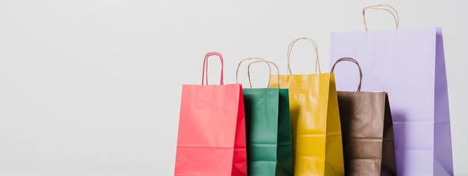 a row of colorful shopping bags sitting on top of each other