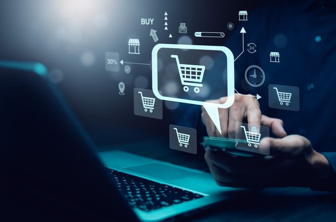 a person using a laptop with icons such as add to cart function