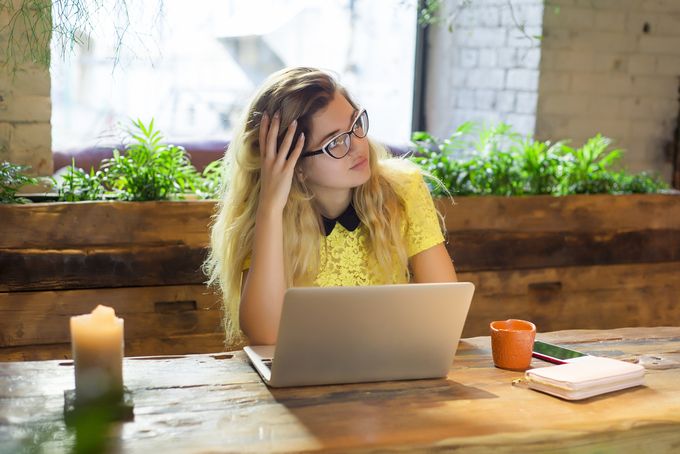 Stressed Shopify seller sitting in front of a laptop computer