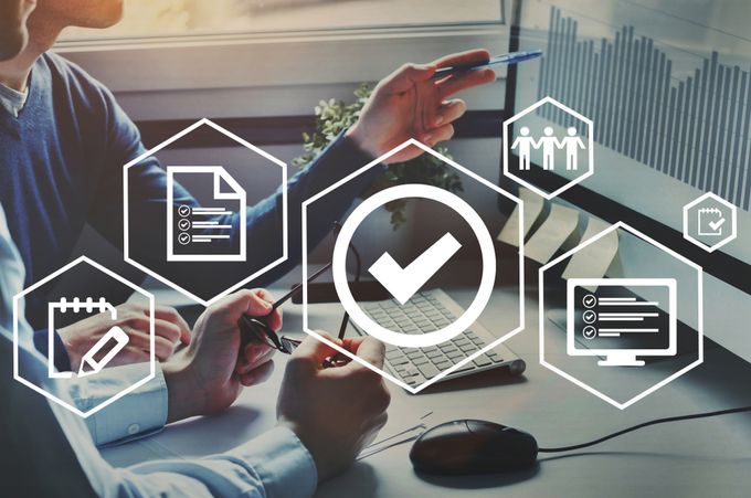 Shopify store owner sitting at a desk with a computer and a mouse organizing their products