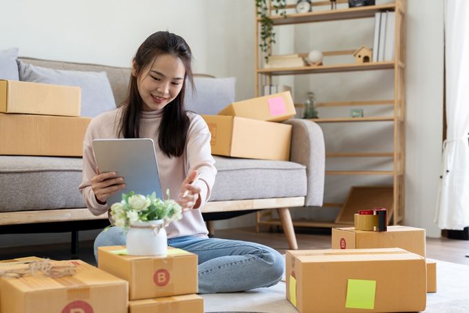 Woman using tablet to prepare orders for online business