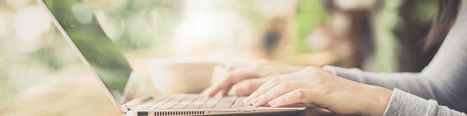 a woman using a laptop computer on a table