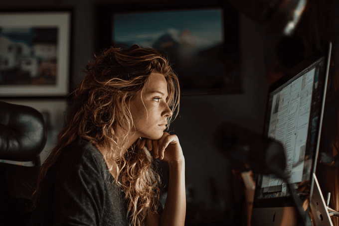 A woman trying to decide on a product and collection sorting app on shopify.