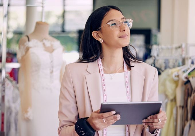 A fashion designer holding a tablet