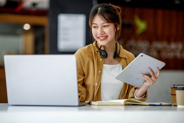 Woman working on a laptop and tablet