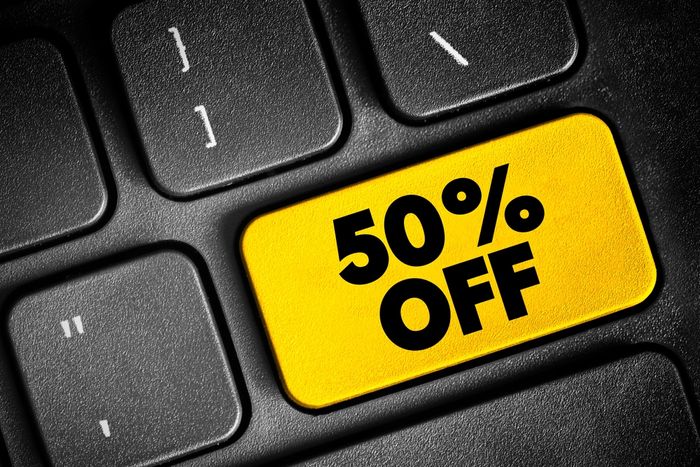 A yellow 50 % off button on a black keyboard