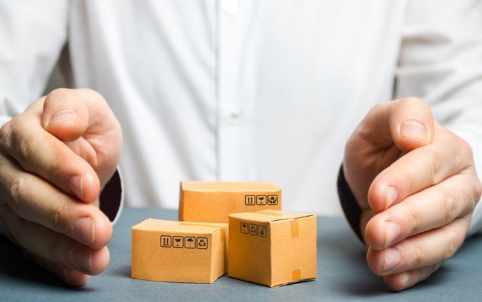 eCommerce merchant holding hands around small boxes of sub collections