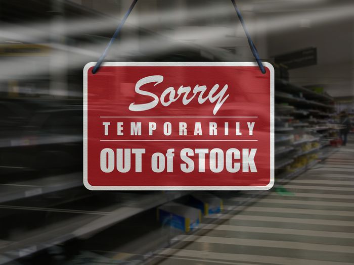 A red sign that says "sorry temporarily out of stock" on the front door of a store