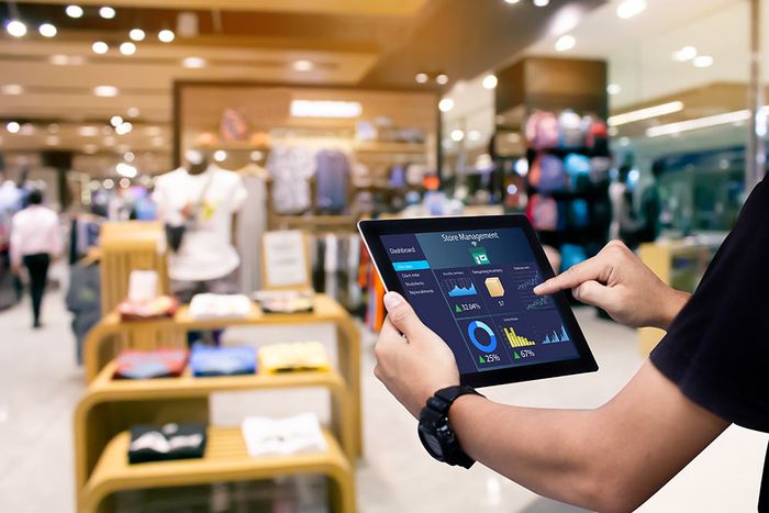 Hands with watch on wrist holding a tablet