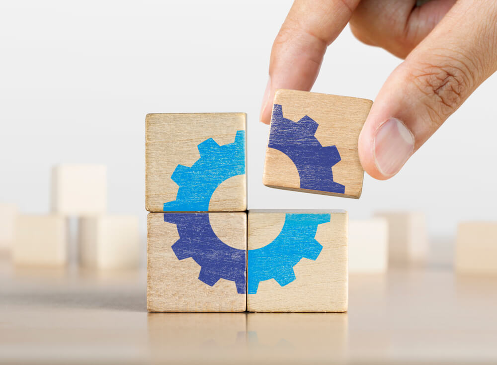 a wooden block with a blue gear on it