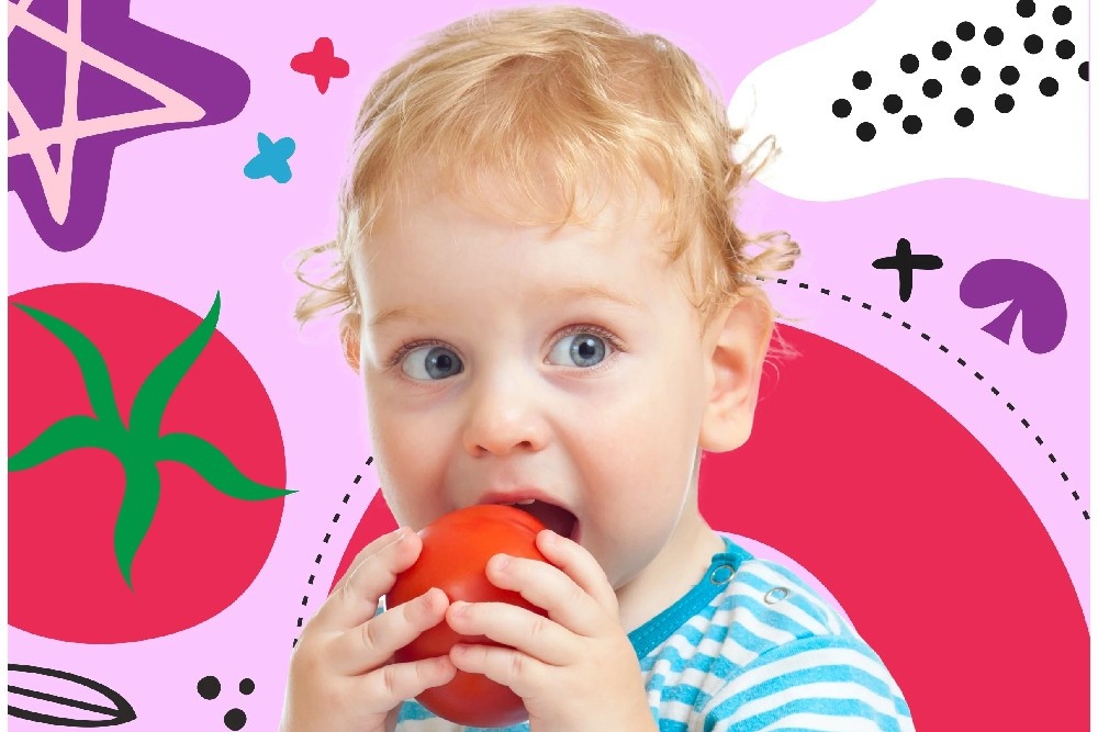 a little boy holding an apple in his hands