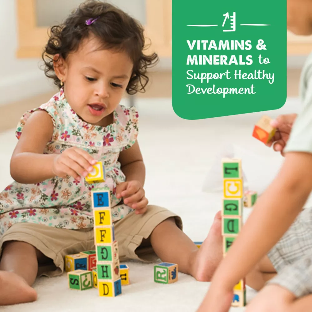 a little girl playing with blocks on the floor