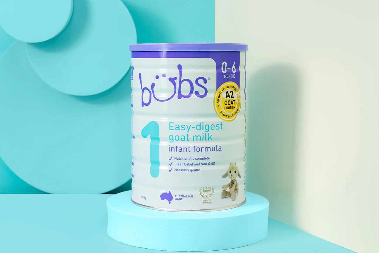 a can of baby milk sitting on a blue shelf