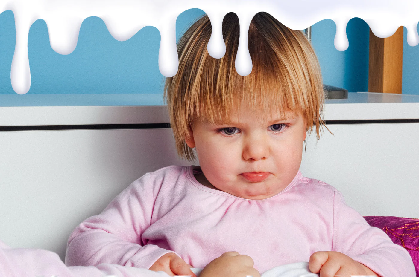 A little girl sitting on a bed - Signs Your Toddler Could Be Lactose Intolerant