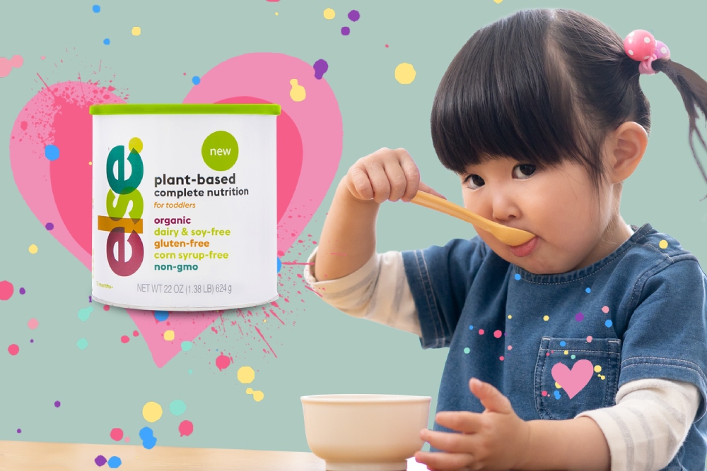 a little girl eating from a bowl with a spoon