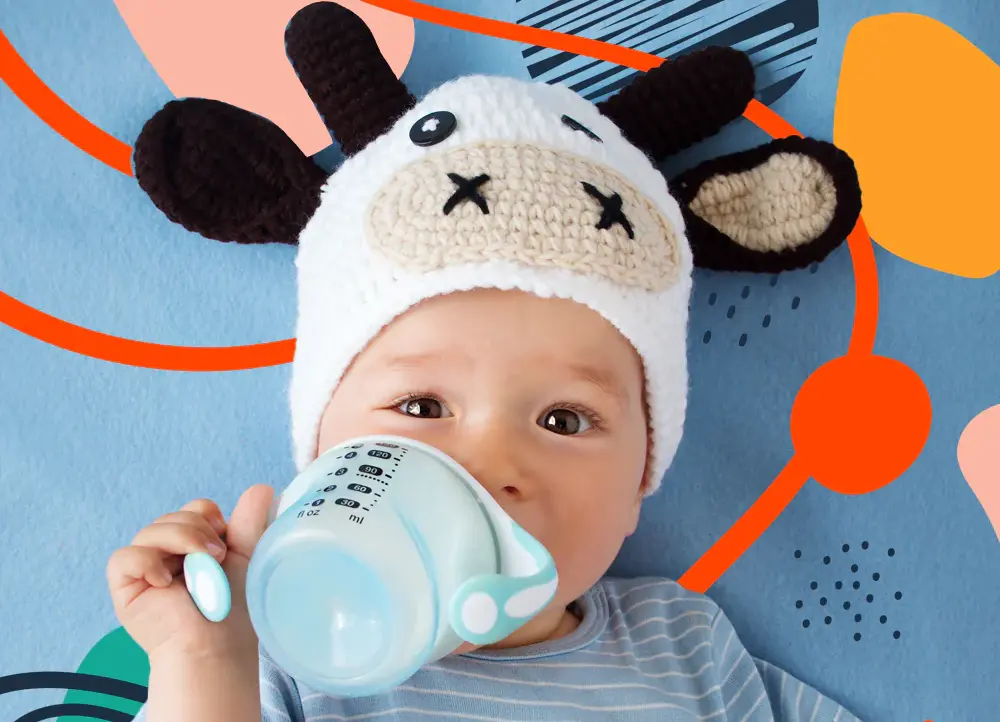 a baby wearing a hat drinking from a cup