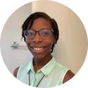 a woman wearing glasses and a green shirt