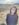 a woman standing in a field with mountains in the background