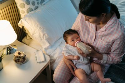 A mom feeding a dairy-free formula to her baby.