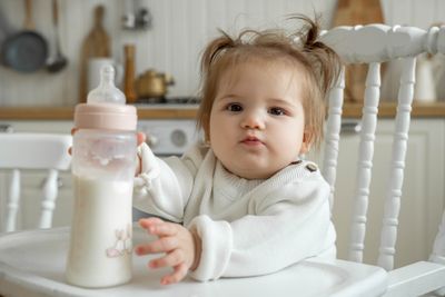 A baby holding a formula.