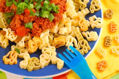 A blue plate filled with healthy food for picky eaters.