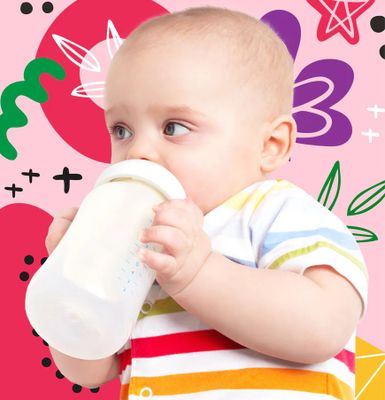 a baby drinking from a bottle while wearing a striped shirt