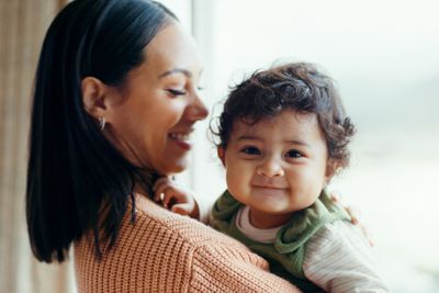 a woman holding a baby in her arms