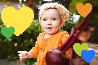 a little girl with a bunch of hearts above her head