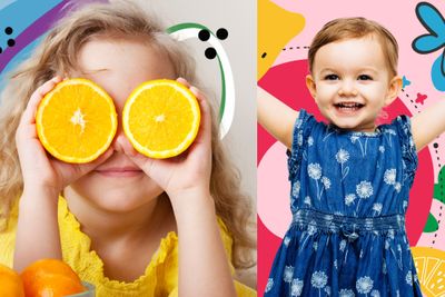 a little girl holding two oranges in front of her eyes