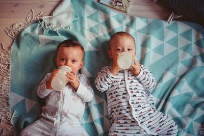 a couple of babies laying on top of a blanket