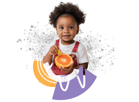 a little girl holding an orange in her hands