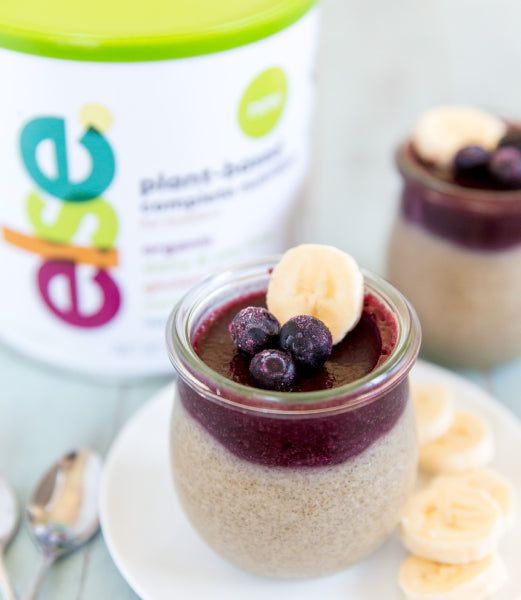 a dessert in a jar with a banana and blueberry topping