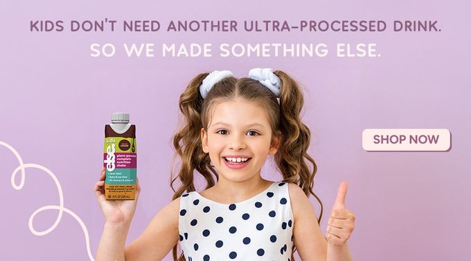 a little girl holding up a bottle of else nutrition