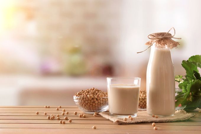 a glass of milk and a bottle of milk on a table