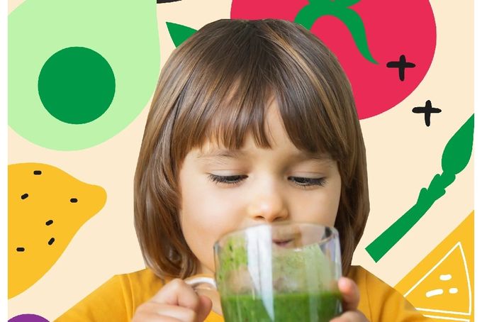 a little girl is drinking a green smoothie