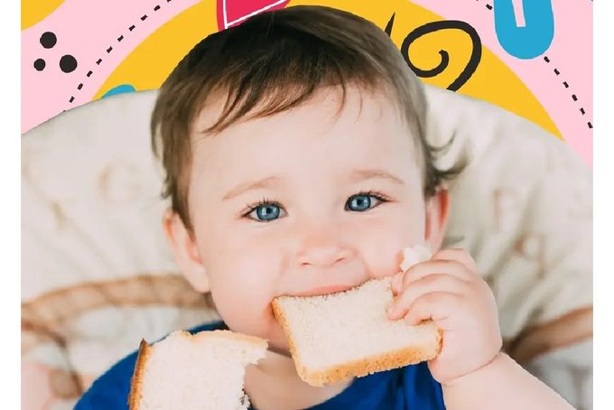 a baby is eating a piece of bread